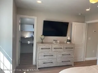 a bedroom with a bed and chandelier