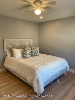 216 Eisenhower Avenue Seaside Heights, NJ 08751 - Photo 25 of 43 a bedroom with a bed and chandelier
