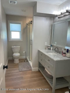216 Eisenhower Avenue Seaside Heights, NJ 08751 - Photo 26 of 43 a bathroom with a double vanity sink a toilet and a mirror