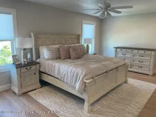 a bedroom with a large bed and a flat tv screen