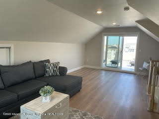 216 Eisenhower Avenue Seaside Heights, NJ 08751 - Photo 30 of 43 a living room with furniture and a wooden floor