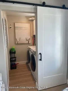 a utility room with mirror and washer