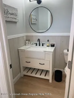 a bathroom with a toilet a sink and a mirror