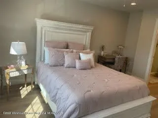 a bedroom with a bed and a mirror