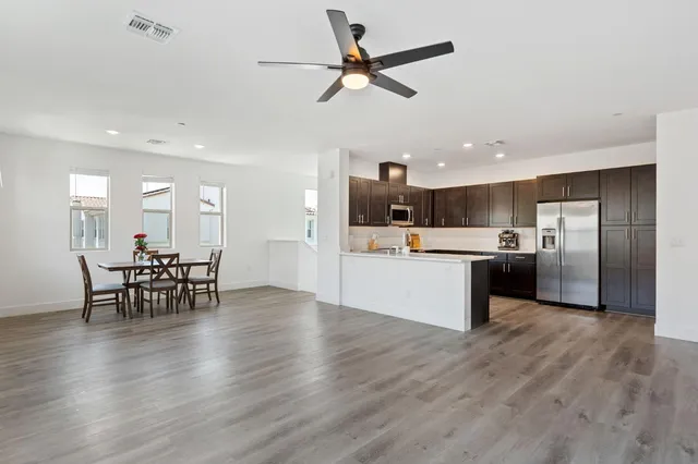 a view of a kitchen with a sink and a refrigerator