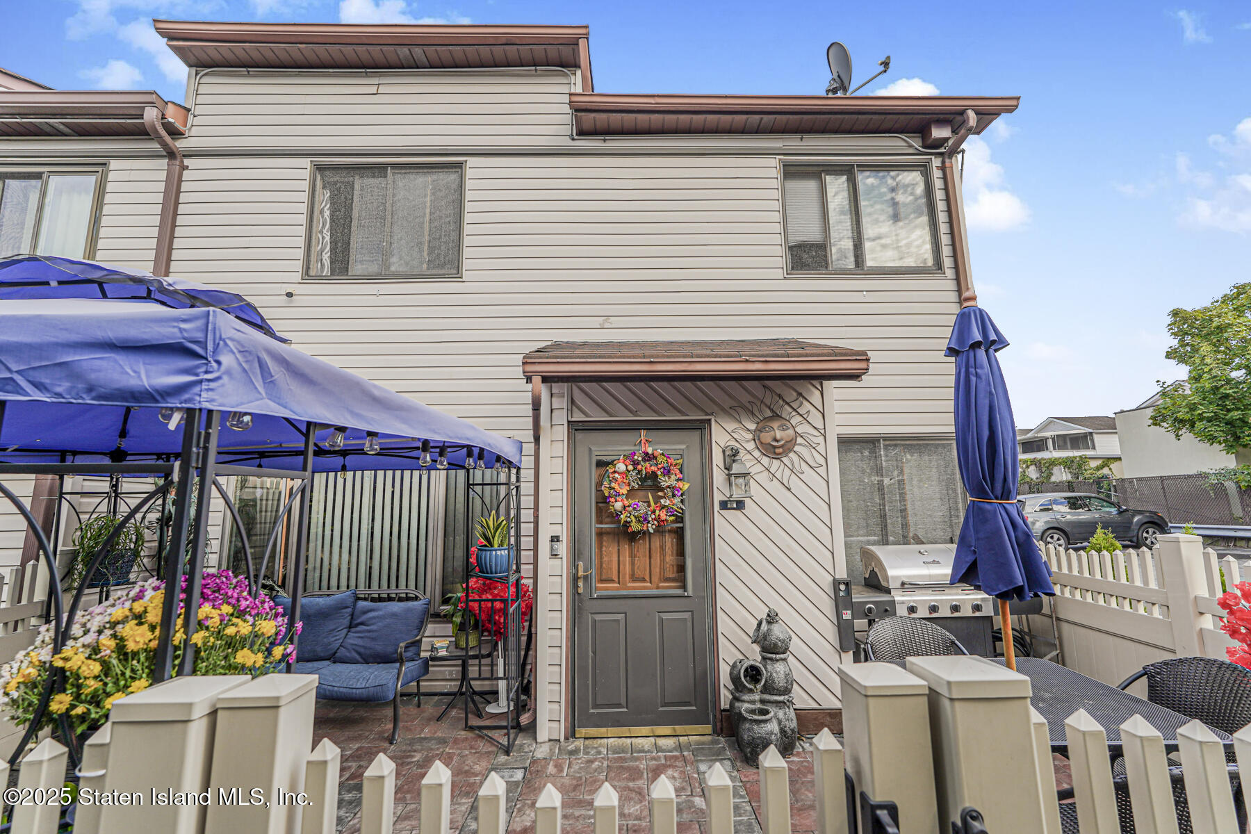 a view of a two chairs and tables in patio