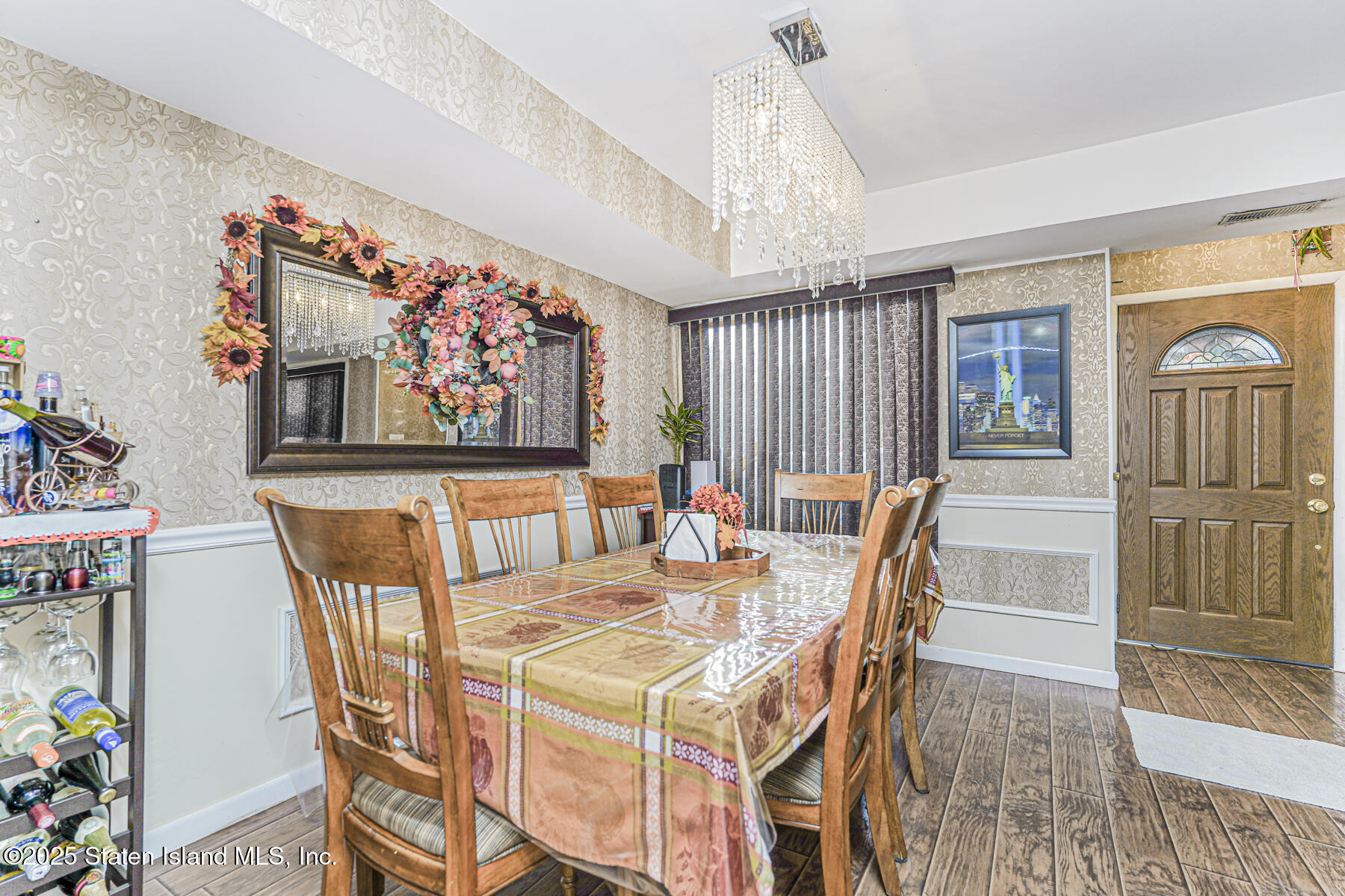 81 Selvin Loop, Unit A Staten Island, NY 10303 - Photo 11 of 25 a dining room with furniture a chandelier and wooden floor