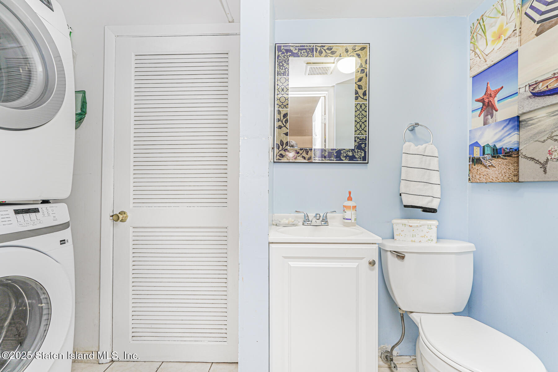 81 Selvin Loop, Unit A Staten Island, NY 10303 - Photo 13 of 25 a bathroom with a toilet a sink and a mirror