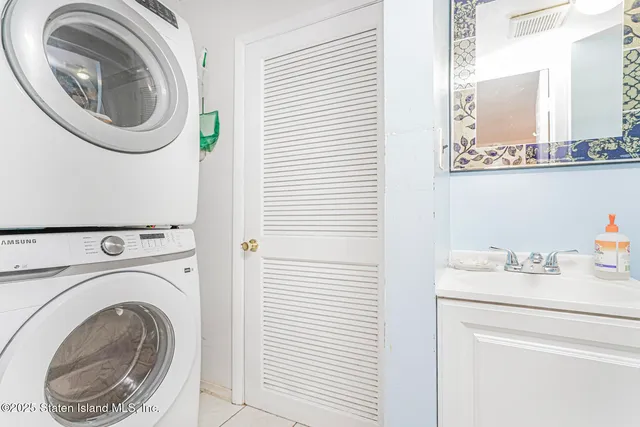 a utility room with sink dryer and washer