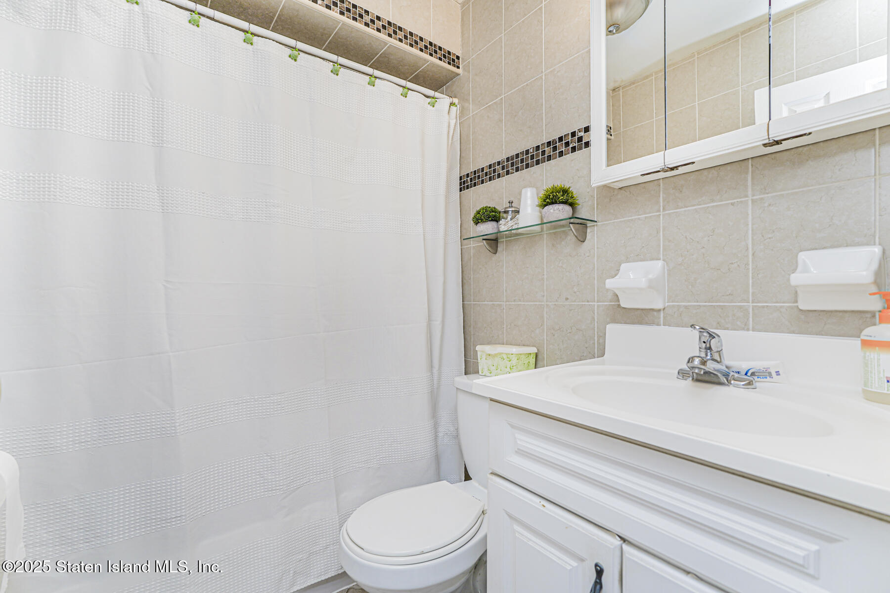81 Selvin Loop, Unit A Staten Island, NY 10303 - Photo 15 of 25 a bathroom with a sink a toilet and shower