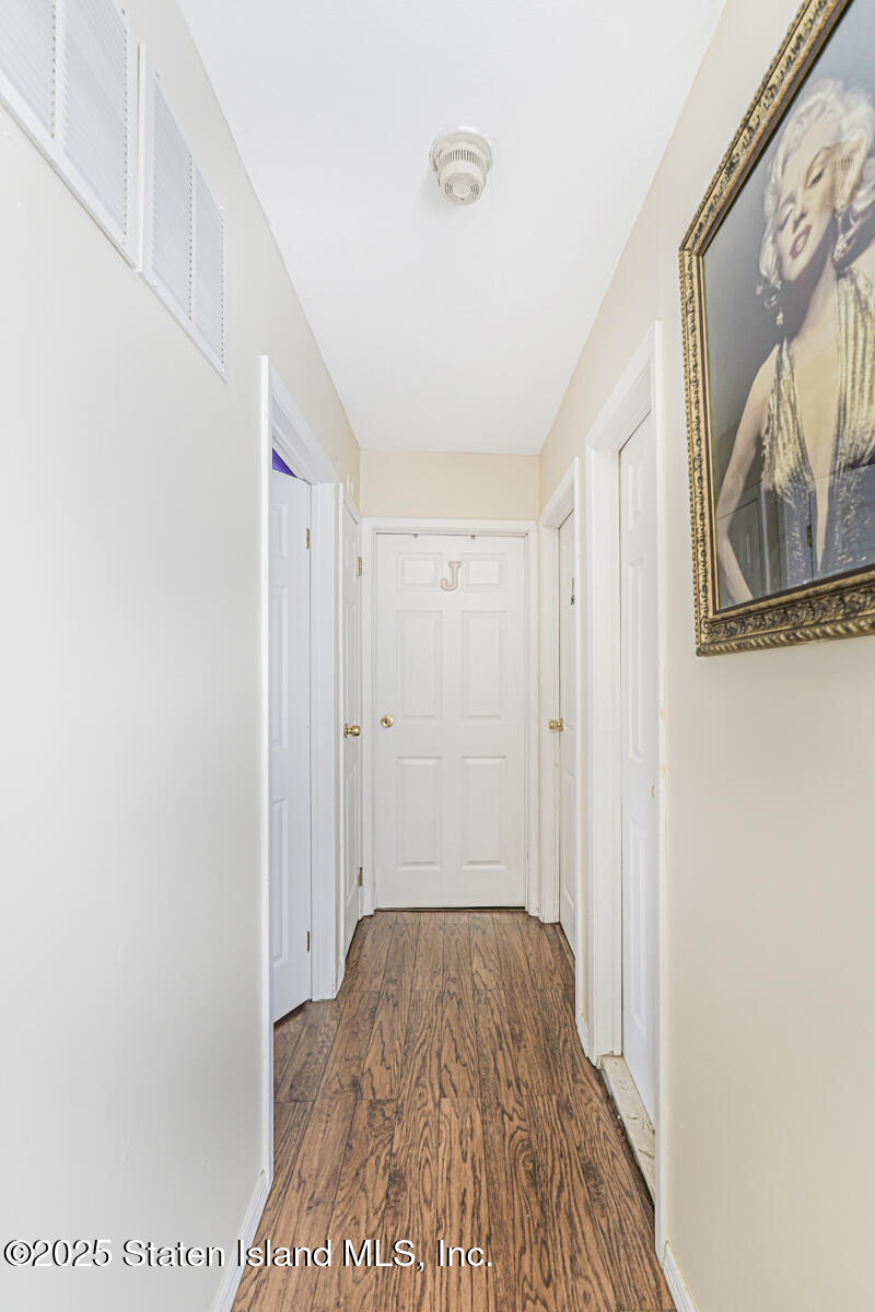 81 Selvin Loop, Unit A Staten Island, NY 10303 - Photo 19 of 25 a view of a room with wooden floor and door