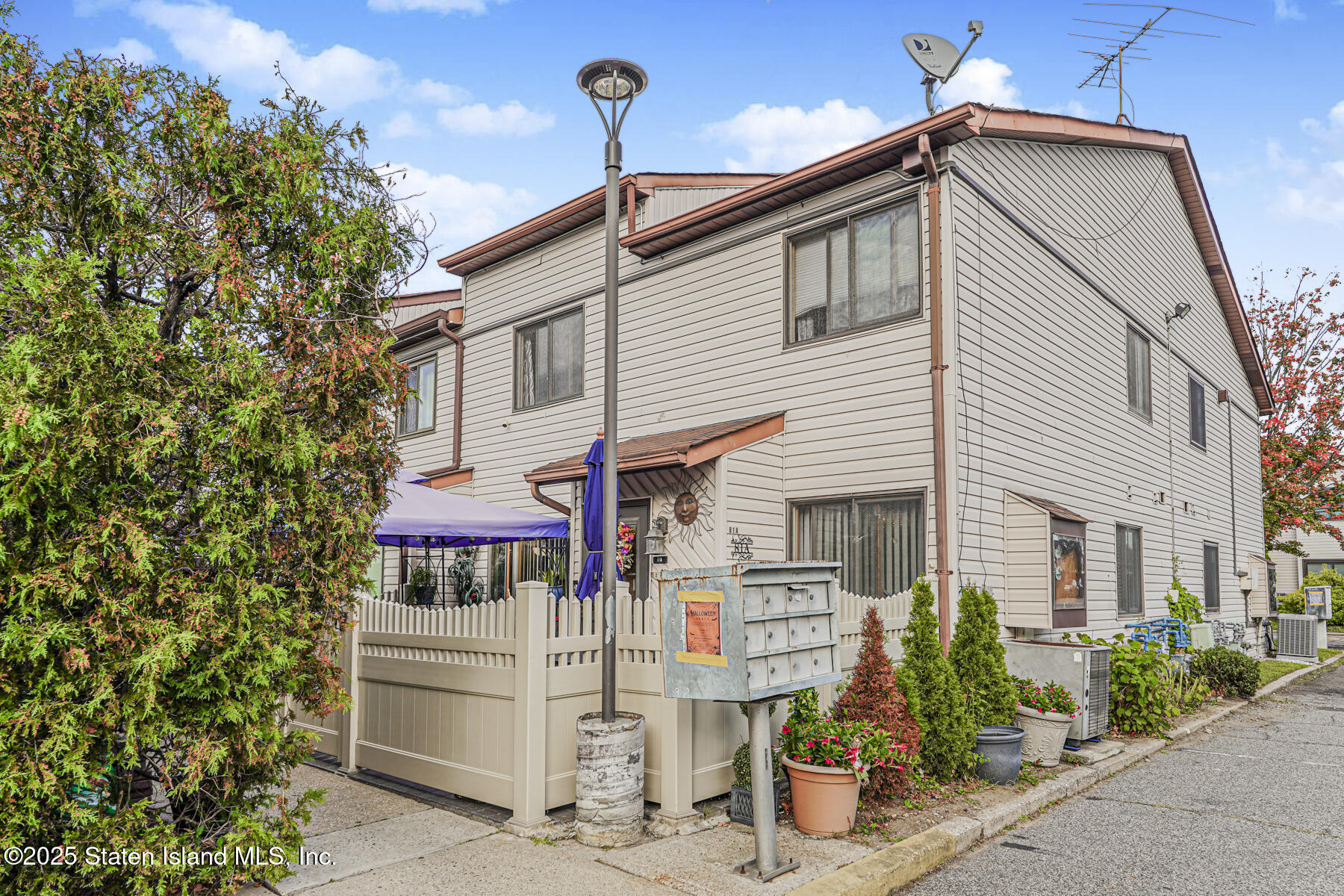 81 Selvin Loop, Unit A Staten Island, NY 10303 - Photo 2 of 25 a front view of a house with a garage