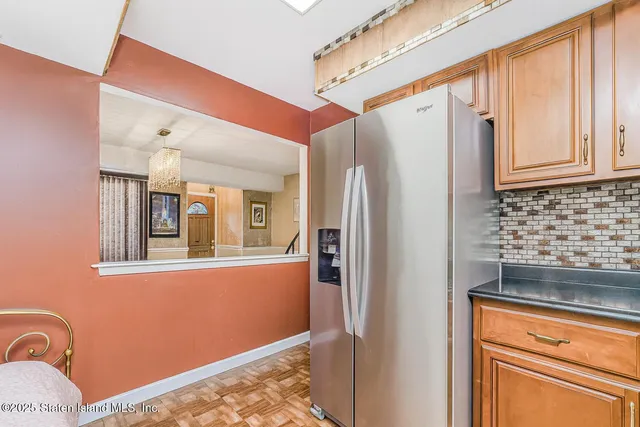 a kitchen with stainless steel appliances granite countertop a refrigerator and a stove