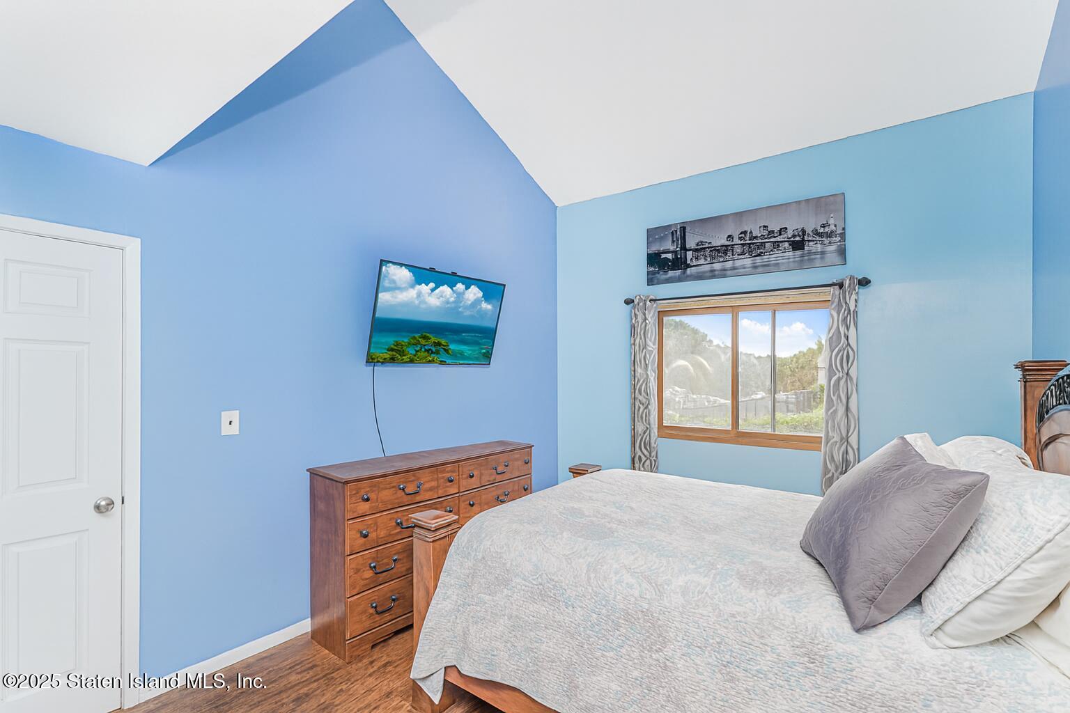 81 Selvin Loop, Unit A Staten Island, NY 10303 - Photo 22 of 25 a bedroom with a bed and a window