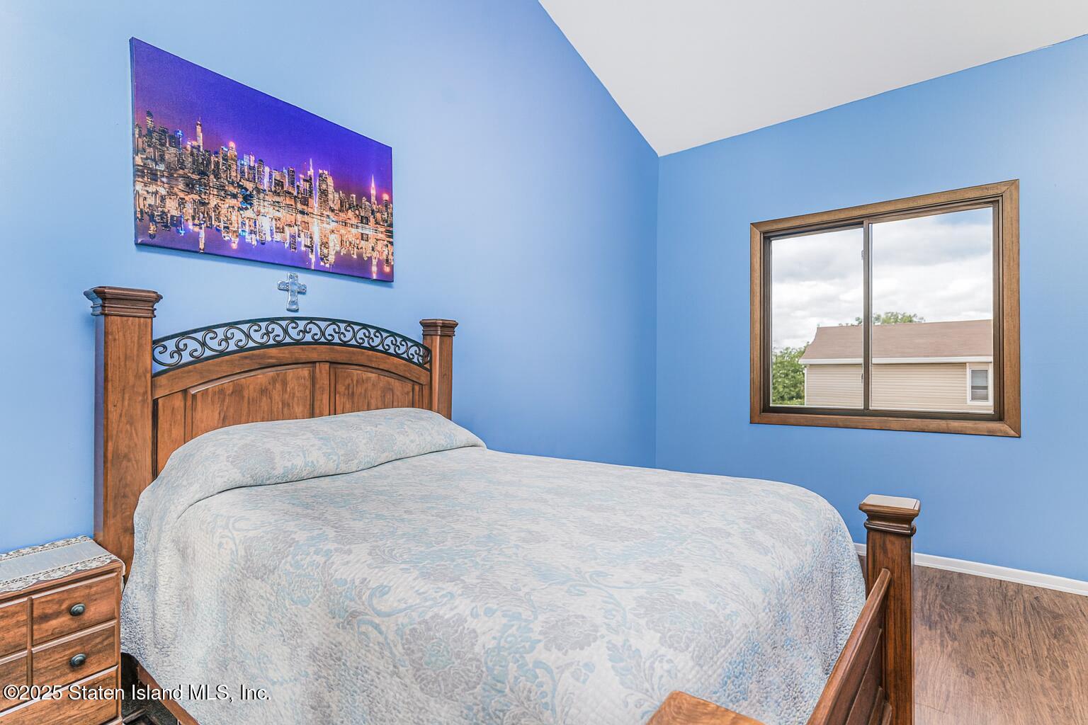 81 Selvin Loop, Unit A Staten Island, NY 10303 - Photo 23 of 25 a bedroom with a bed and painting on the wall