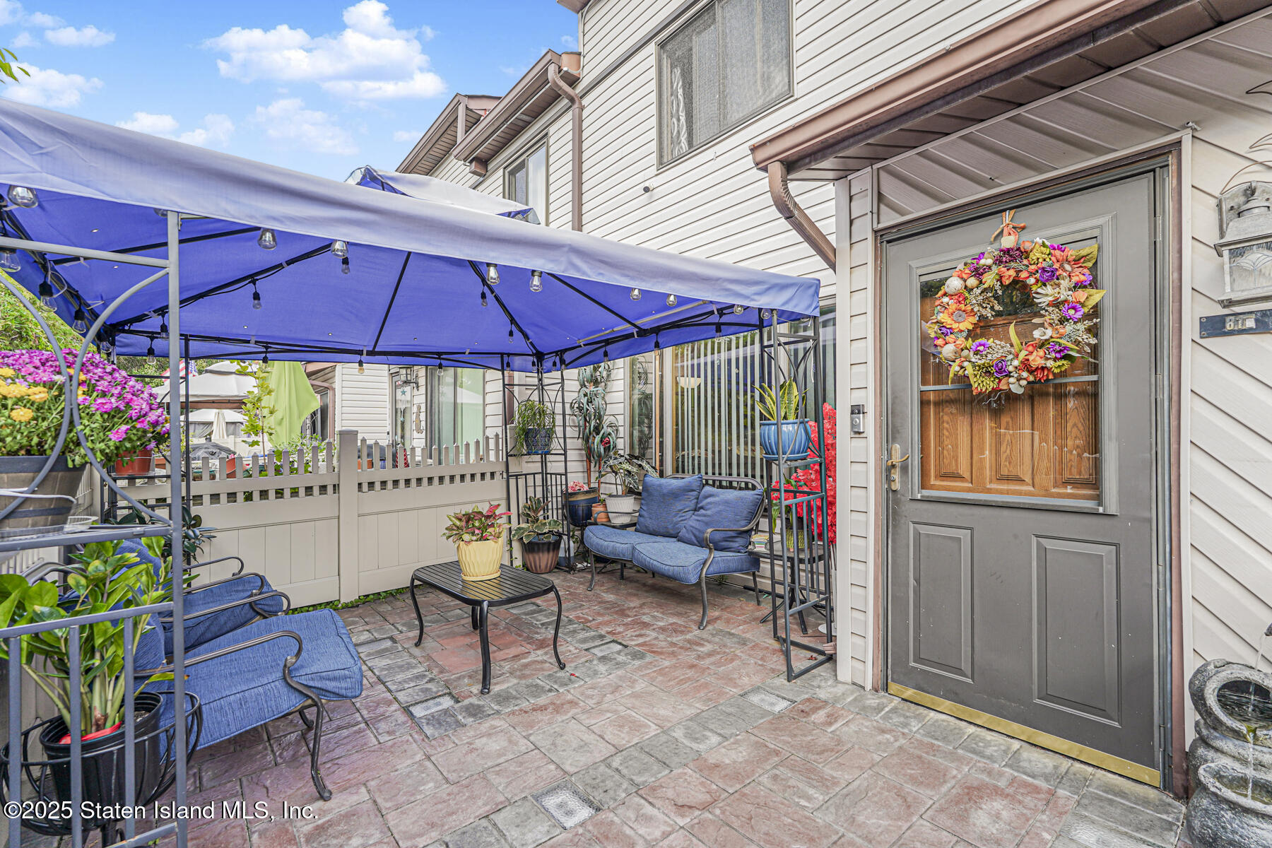81 Selvin Loop, Unit A Staten Island, NY 10303 - Photo 3 of 25 a view of patio with a table and chairs under an umbrella