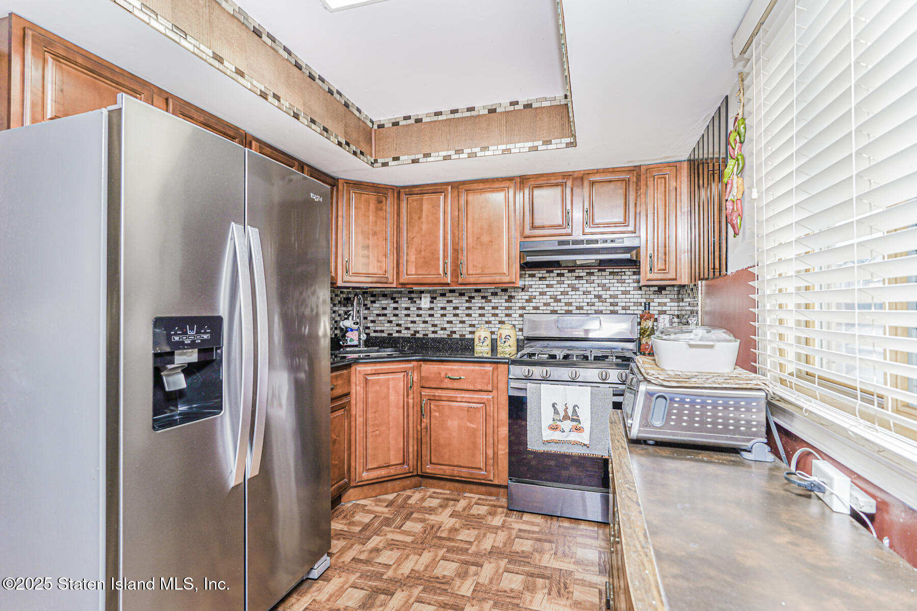 81 Selvin Loop, Unit A Staten Island, NY 10303 - Photo 10 of 25 a kitchen with stainless steel appliances granite countertop a refrigerator a stove and sink