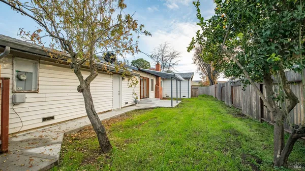 a view of a house with backyard and a garden