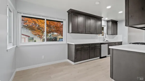 a kitchen with stainless steel appliances granite countertop a sink and a stove