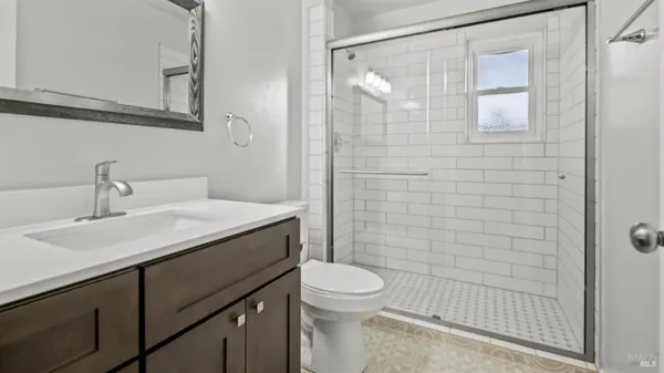 a front view of a house with a garden and yard