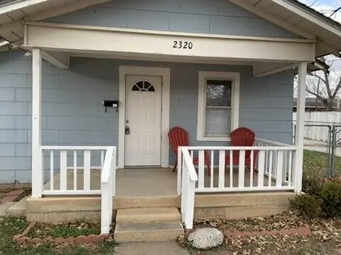 a view of a house with a small yard and wooden floor and a window