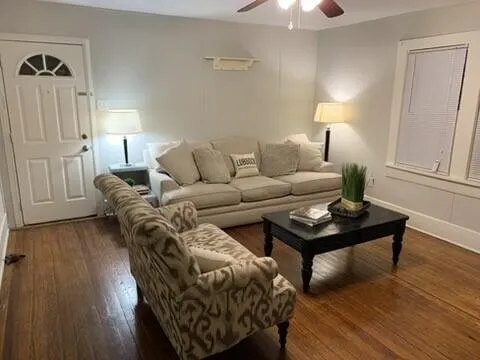 a living room with furniture and a lamp