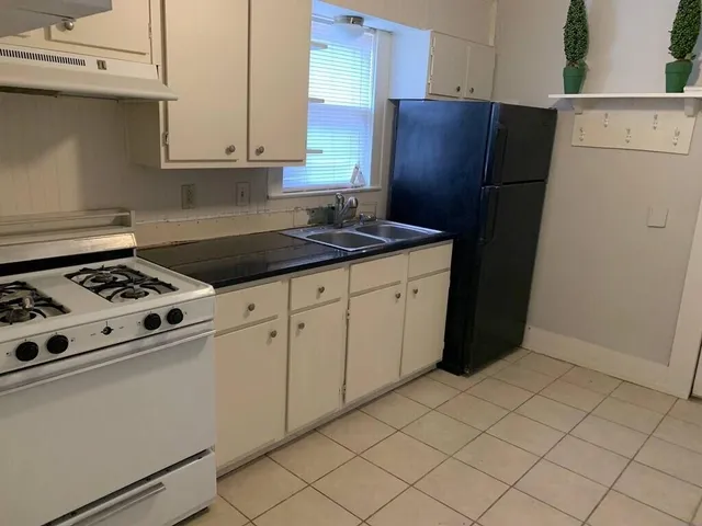 a kitchen with stainless steel appliances granite countertop a refrigerator and a stove