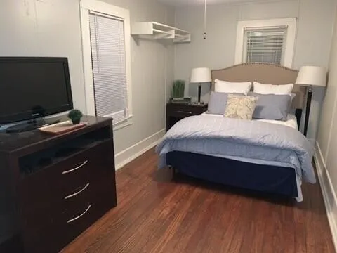a bedroom with a bed and a flat screen tv