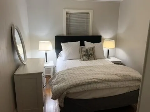 a bedroom with a bed and a lamp
