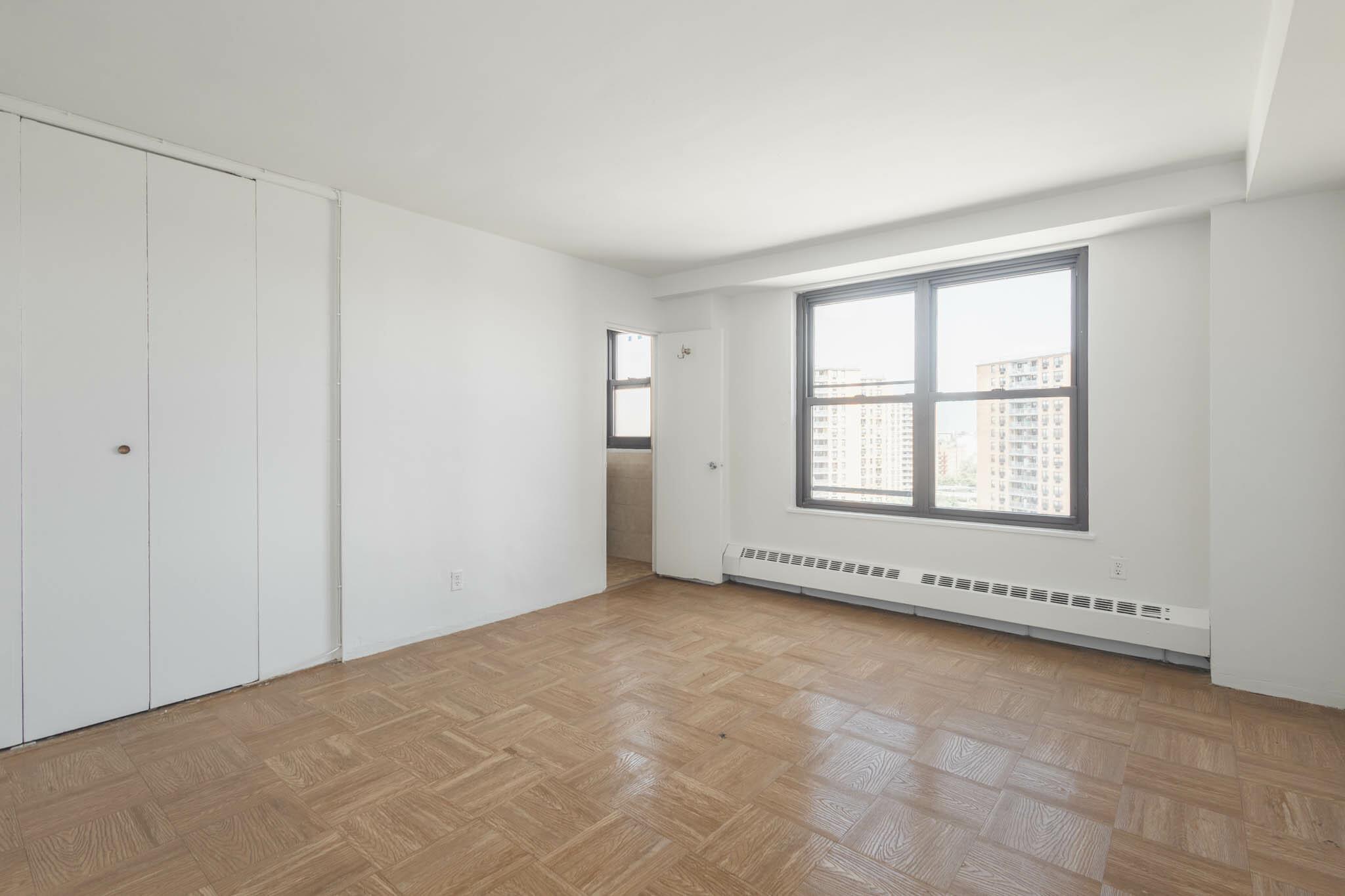 61-25 98th Street, Unit 11E Queens, NY 11374 - Photo 13 of 31 an empty room with windows