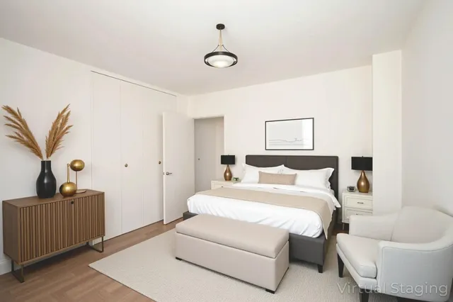 a bedroom with a white bed and a couch