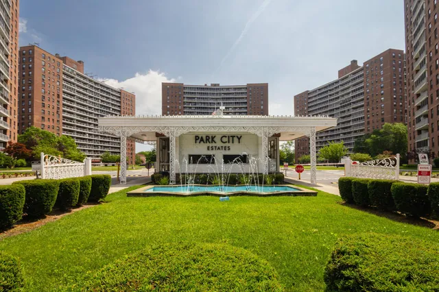 a view of a house with a big yard and sitting area