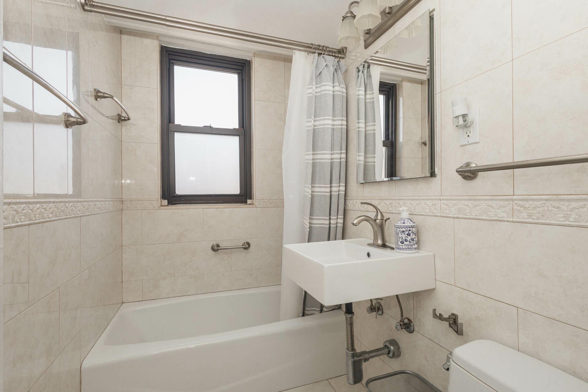 61-25 98th Street, Unit 11E Queens, NY 11374 - Photo 22 of 31 a bathroom with a sink toilet and shower