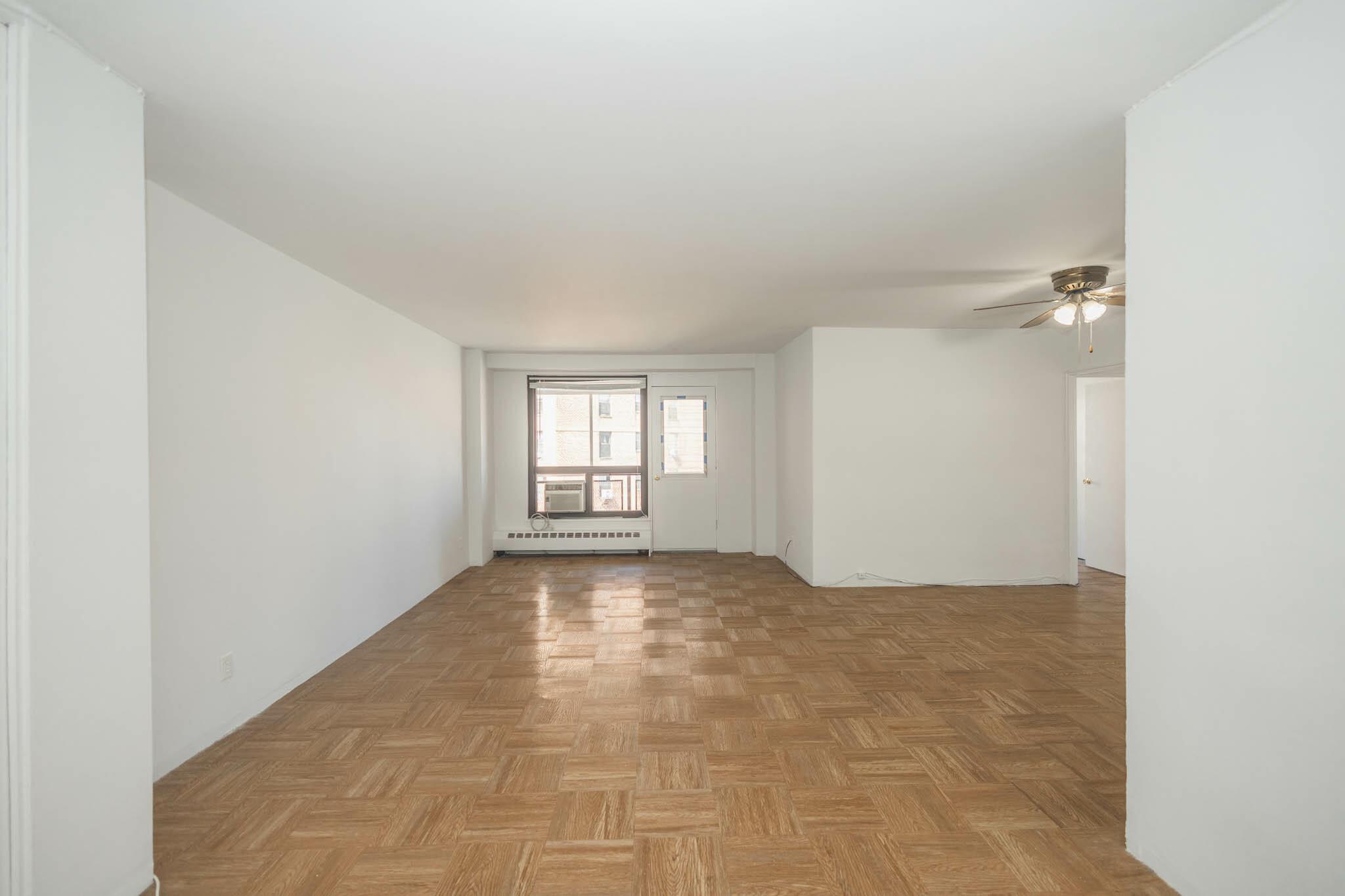 61-25 98th Street, Unit 11E Queens, NY 11374 - Photo 7 of 31 a view of an empty room and window