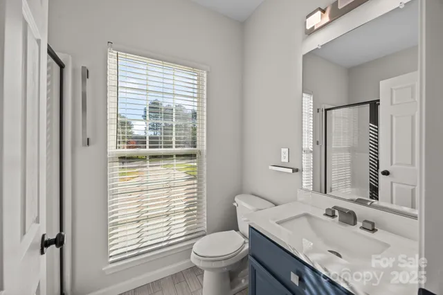 a bathroom with a shower and a glass door