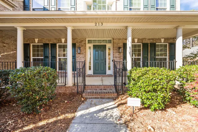 front view of a brick house with a large window