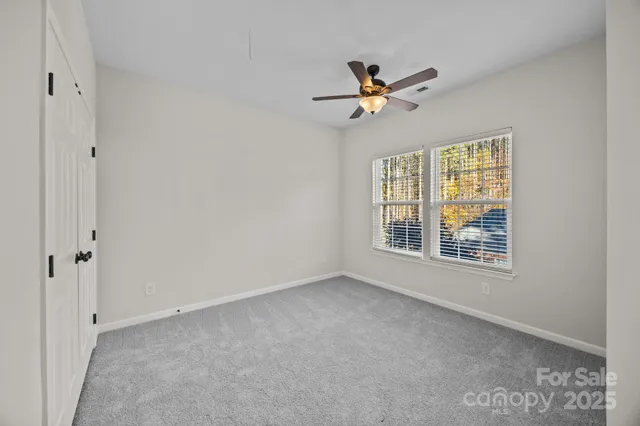 a view of a hallway with wooden floor and windows