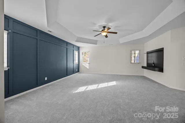 a spacious bathroom with a tub sink and mirror