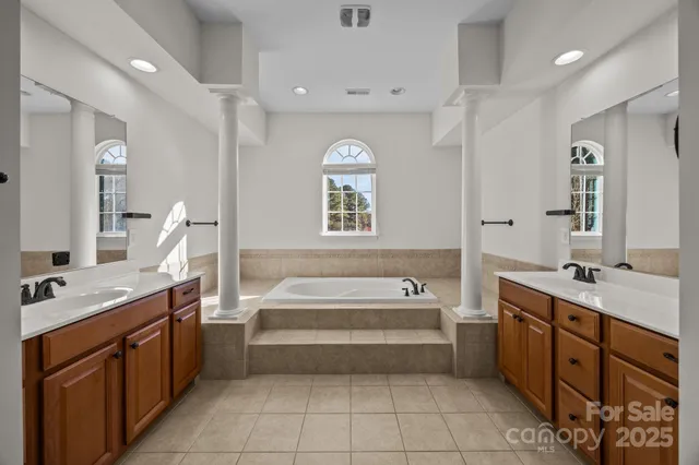 a bathroom with a granite countertop sink mirror and vanity