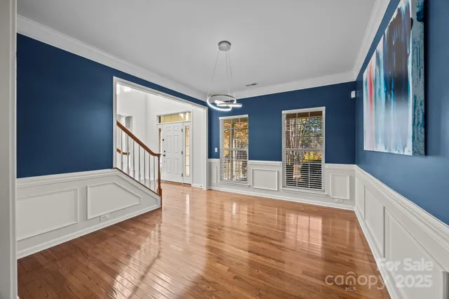 a view of an entryway with wooden floor and door