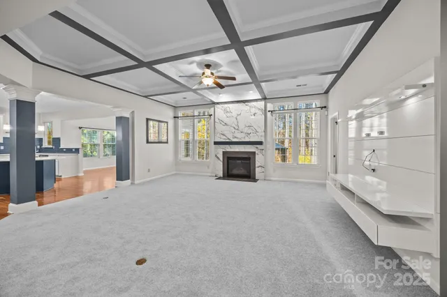 a large hall with a fireplace and chandelier