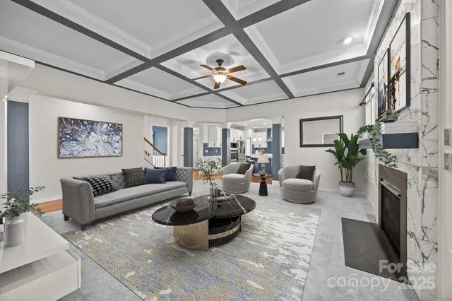 a living room with furniture a fireplace and a chandelier