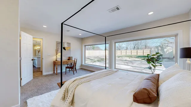 a bed room with a bed and a large window