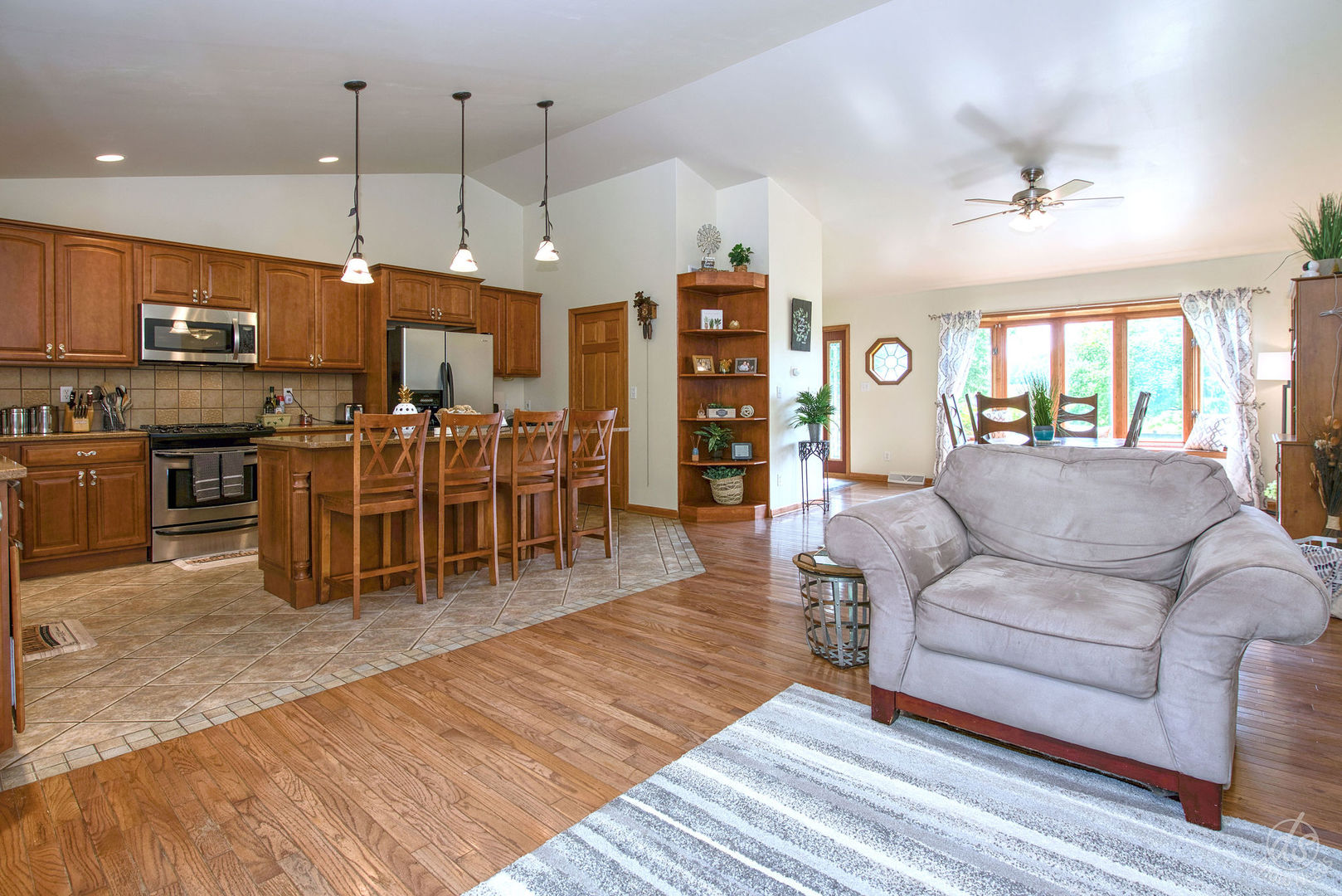 28671 Moose Range Road Sycamore, IL 60178 - Photo 11 of 69 a living room with furniture a wooden floor and a kitchen view