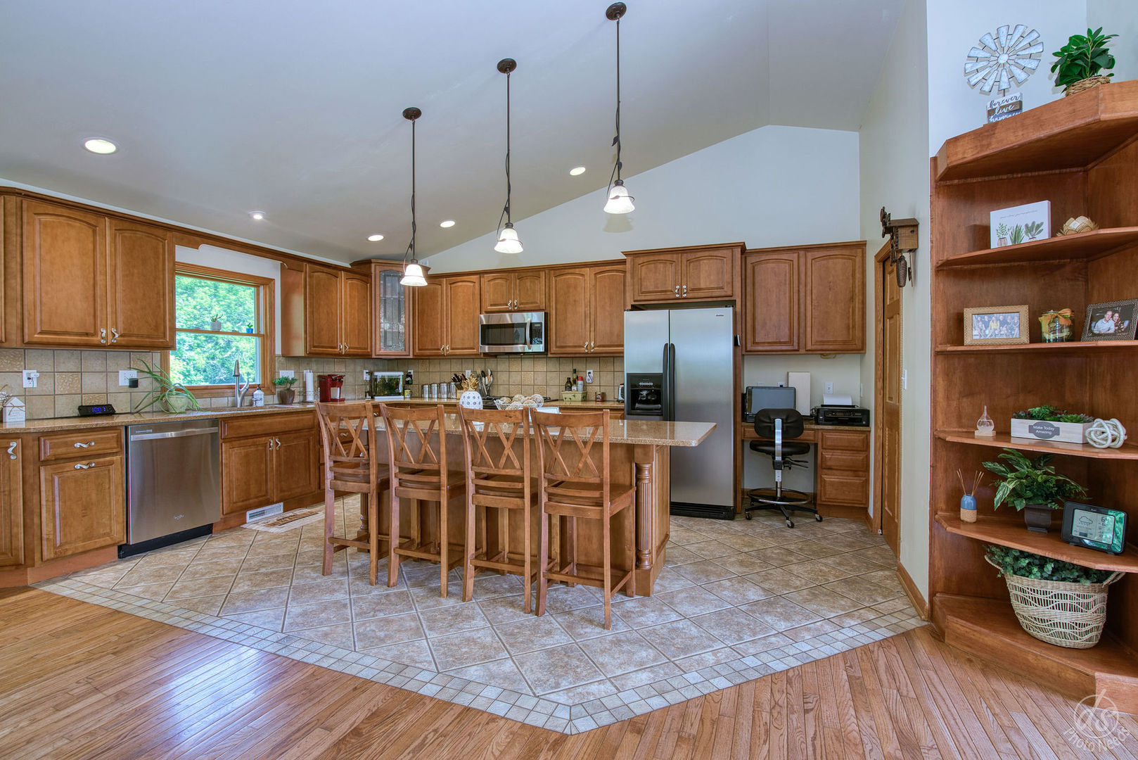 28671 Moose Range Road Sycamore, IL 60178 - Photo 12 of 69 a kitchen with stainless steel appliances kitchen island granite countertop a refrigerator a stove a sink and a dining table with wooden floor
