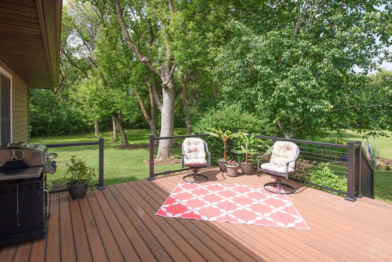 28671 Moose Range Road Sycamore, IL 60178 - Photo 41 of 69 a view of a deck with couches table and chairs and wooden floor
