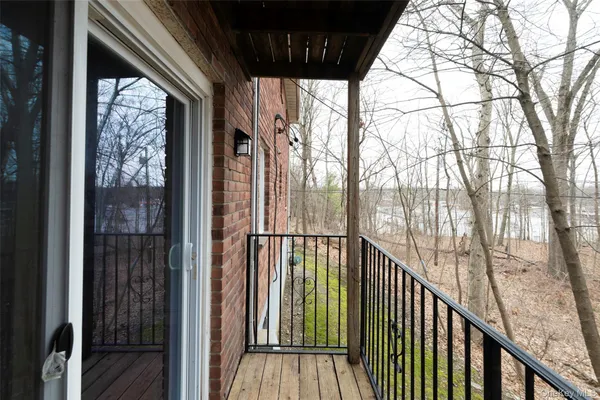a view of balcony with wooden floor