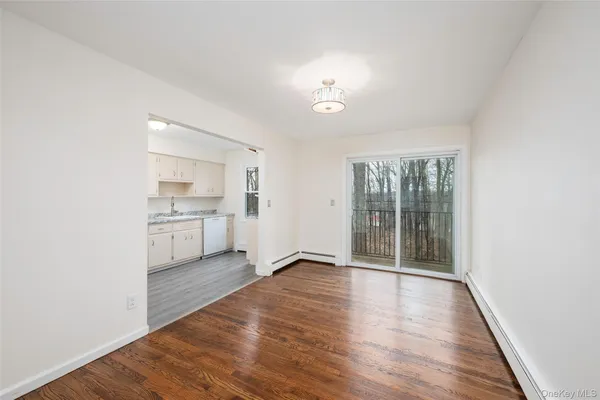 a view of a kitchen with wooden floor and a sink