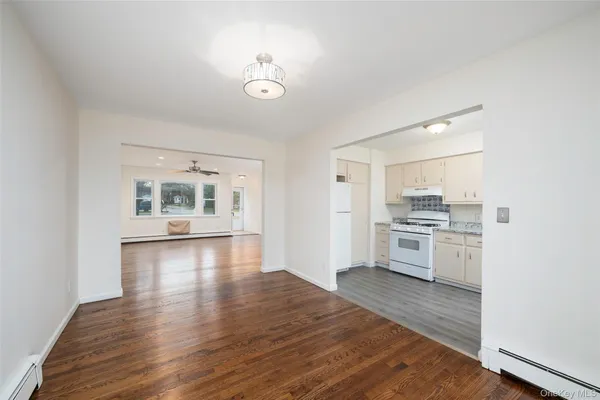 a view of open kitchen with wooden floor and electronic appliances