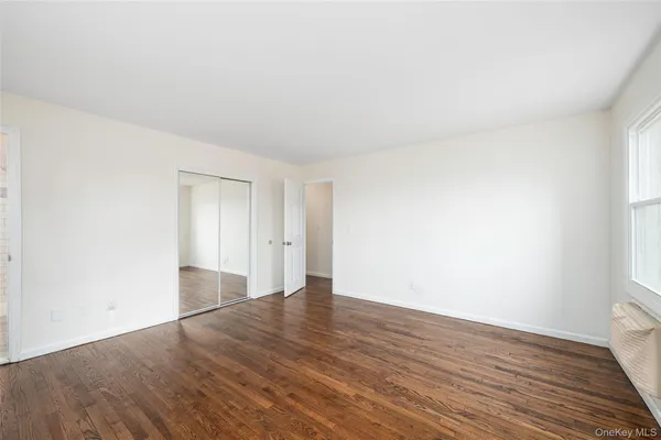 a view of an empty room and wooden floor